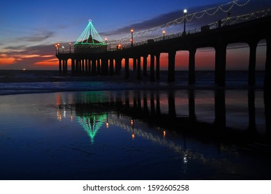 Sunset With Sand Beach And Silhouette Of Manhattan Beach Pier, California