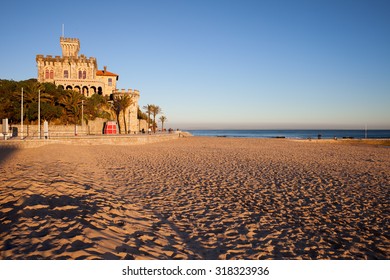 Sunset at sandy Tamariz beach by the Atlantic Ocean in resort town of Estoril, municipality of Cascais, Portugal.