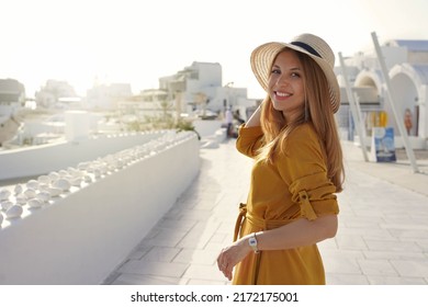 Sunset in Santorini. Romantic attractive young woman turns around and looking at camera in Santorini, Greece. - Shutterstock ID 2172175001