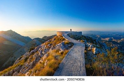 Sunset scene at Mausoleum of Njegos on mountain Lovcen, Montenegro, Europe. Person looking at mountains. - Powered by Shutterstock
