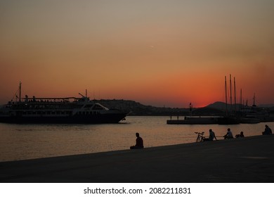 Sunset Scene Of People Silhouettes At Plateia Nerou (Water Plaza).
Athens, Greece, November 2021.