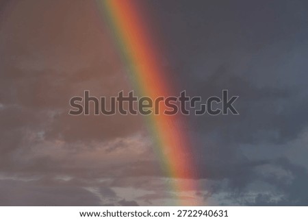 Sunset scene with a rainbow, emanating from bottom edge Warm pink and orange sky White textured border Realistic surrealism style Viewpoint invites emotional engagement