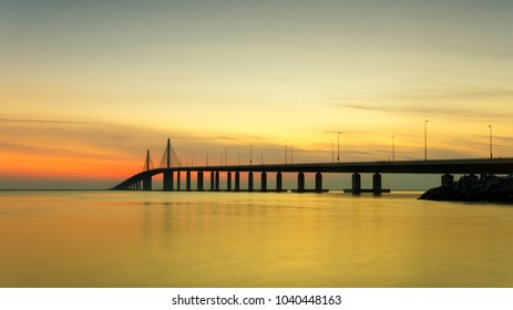 Sunset at the sea with bridge over the peaceful water panorama - Shutterstock ID 1040448163