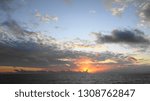 SUNSET AT SEA WITH CLOUDS