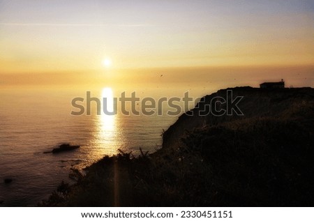 sunset at sea,  photo made with a diffusing filter to give it a feeling of fantasy and mystery, Promotional photography of the landscape of Asturias, Spain, around the Cape Vidio lighthouse