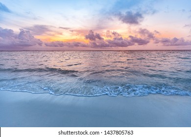 Sunset sea sand sky. Beautiful beach nature, soft sunlight and splashy waves cloudy colorful sky with sunlight. Tranquil beach landscape, calmness and inspiration view. Ocean water ecology concept