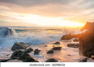 sunset seascape with rocky beach and crashing waves  - Powered by Shutterstock