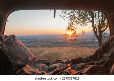 Sunset seen from the back of a camper with amazing landscape. Adventure trip with amazing feeling. Concept of nature and having freedom in holiday