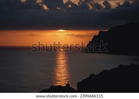 Sunset seen from Ionian Sea coast on near Sinarades village on Corfu Island, Greece