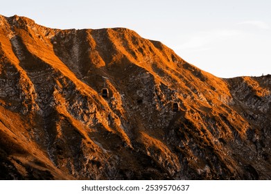 Sunset Serenity: Mountain Cabins and Cable Cars Against the Majestic Alpine Landscape - Powered by Shutterstock