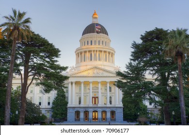 Sunset shines on top dome of California state capitol building in Sacramento