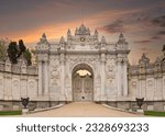 Sunset shot of closed gate leading to former Ottoman Dolmabahce Palace, or Dolmabahce Sarayi, suited in Ciragan Street, Besiktas district, Istanbul, Turkey. View from the internal court