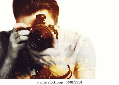 Sunset shot. Digitally composed close-up picture of young photographer looking threw his camera over the picture of landscape with palm trees - Powered by Shutterstock