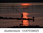 Sunset  And Silhouette Fisherman At North Chennai Buckingham Canal With Orange Color Sky Background