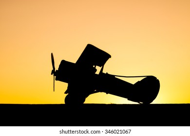 Sunset Silhouette Of Old Bi Plane