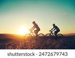 Sunset, silhouette and people on bicycle with adventure, race and exercise in nature together. Cycling, fitness and friends with mountain bike in evening for outdoor workout, blue sky and grass path