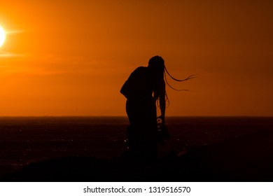 Sunset Silhouette: Same Sex Couple Of Girls At Sunset In Camps Bay Tidal Pool, Cape Town, South Africa