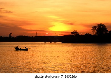 Sunset and silhouette Small fishing boat in Songkhla lake Thailand