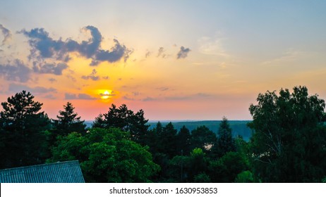 Sunset and silhouette of trees.