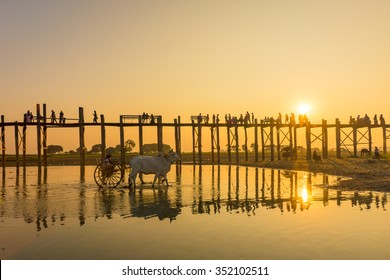 Sunset with silhouettes of people on Bridge U-Bein teak bridge is the longest.   in Amarapura ,Mandalay ,Myanmar - Shutterstock ID 352102511