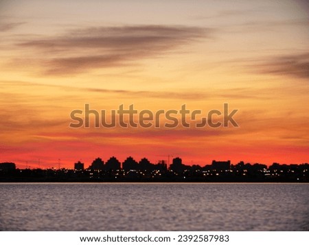 Sunset silhouettes Tarragona’s skyline against fiery skies.