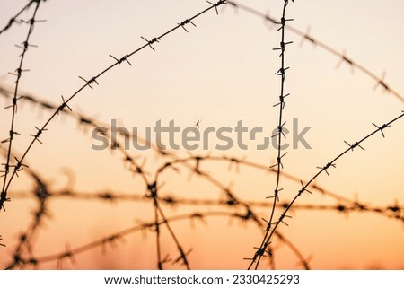 Sunset sky and barbed wire