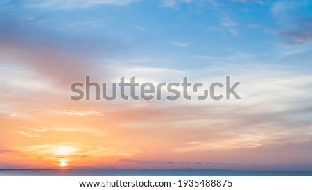 Sunset sky beautiful clouds over sea in the Evening with Orange, Yellow colorful or Romantic Golden Hour sunlight Morning,Beautiful Sky Background, Dusk 