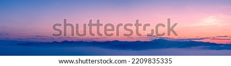 Sunset sky and cloud with fog on mountain background, panorama view