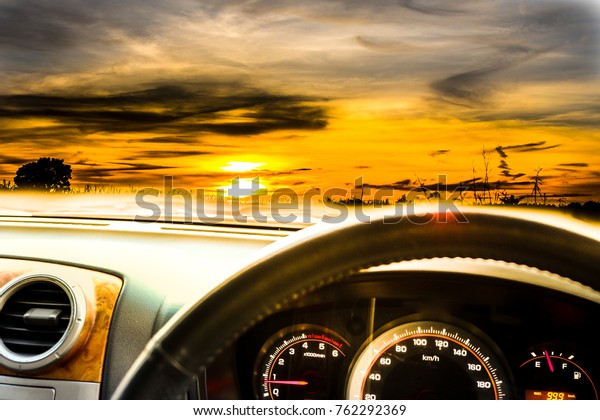 Sunset sky with cloud and warm light background in
font of the car