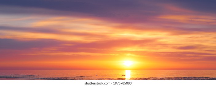 Sunset sky clouds background. Beautiful landscape with clouds and orange sun on sky. High quality photo - Shutterstock ID 1975785083
