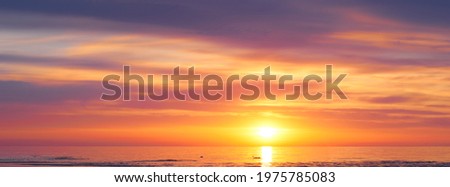 Sunset sky clouds background. Beautiful landscape with clouds and orange sun on sky. High quality photo
