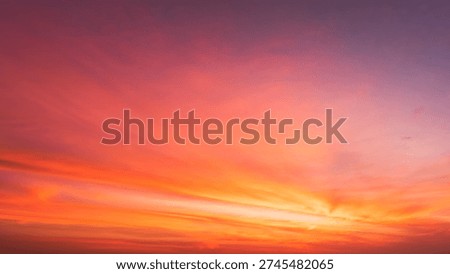 Sunset Sky Clouds Background in the evening with Red, Orange, Yellow and purple sunlight on Golden hour after sundown, Romantic sky in summer on Dusk Twilight 