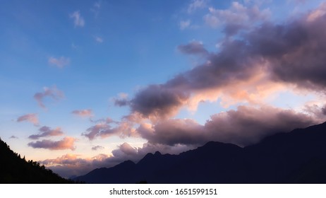 Sunset sky and clouds with dramatic light above the hills.