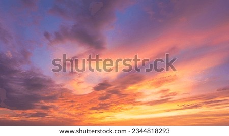 Sunset sky clouds in the evening with colorful orange, yellow, pink and red sunlight and dramatic storm clouds on twilight sky, Landscape horizon sky summer, Dusk sky background 