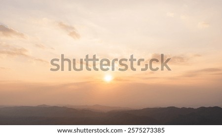 Sunset sky clouds in the Evening over mountain with golden hour orange, yellow sunlight sun dawn, Horizon landscape dusk sky background  
