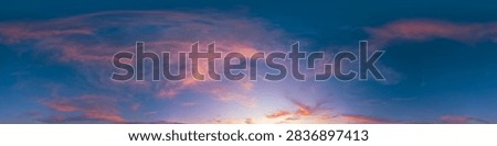 Sunset sky clouds featuring a panoramic view of colorful orange and purple cirrus wisps at dusk over a wide horizon