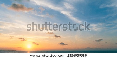 Sunset sky clouds over sea in the Evening with Orange, yellow sunlight on Golden hour, Horizon sea sky landscape 