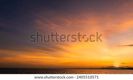 Sunset sky clouds over sea in the Evening with orange sunlight, Horizon sea landscape Sun Sunrise island, Dusk Sky background 