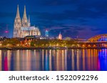 Sunset sky with colors and clouds over the city skyline Cologne with Bridge and Koeln Dom, Evening scene over Cologne Koln city with Kolner Dom Cathedral behind the Hohenzollern bridge.