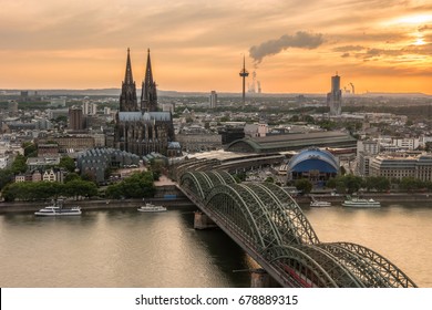 sunset sky with colors and clouds over the city Cologne with Bridge and Köln Dom ,Evening scene over Cologne/Koln city with Kolner Dom/Cathedral behind the Hohenzollern bridge and Koln towers,
