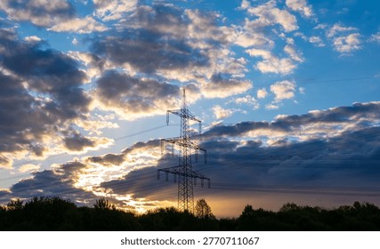 Sunset sky with dramatic clouds, electricity pylon, power lines, tree silhouettes, golden hour lighting, industrial landscape, serene atmosphere dramatic stormy sky, cinematic view weather shifts - Powered by Shutterstock - Get 15% off with code: PIKWIZARD15