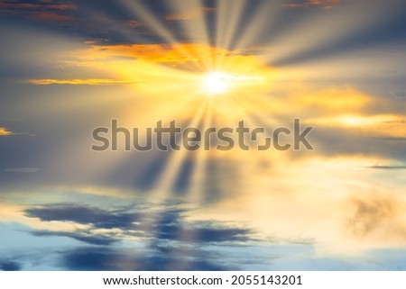 Sunset sky with dramatic clouds and sun shining through cloud. Holy heaven sky landscape
