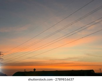 Sunset sky with an electronic wire.