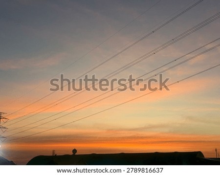 Sunset sky with an electronic wire.