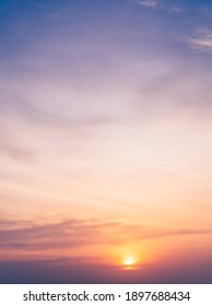 Sunset sky in the evening on twilight with orange and purple sunlight sky nature background,Dusk sky vertical.  