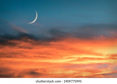 Sunset sky with large crescent moon
