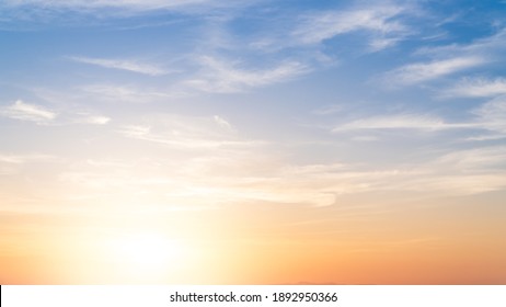 Sunset sky in the Morning with colorful orange sunrise on blue white clouds, Golden sky Background 