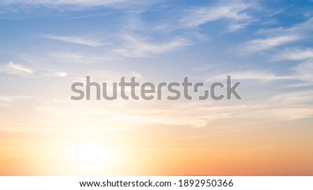 Sunset Sky in the Morning with colorful Yellow, Orange Sunrise on blue white Cloud, Golden Summer Sky Background 