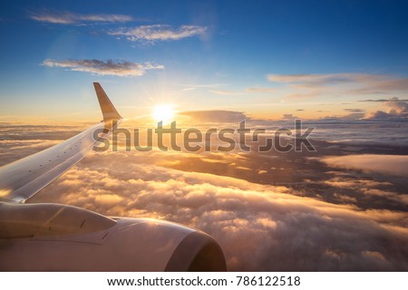 Sunset sky on airplane, plane window, over Copenhagen, Denmark, Scandinavia, Europe in Friday evening flight for relax in holiday