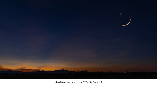 Sunset sky over mountain in the evening on twilight with crescent moon on dusk sky, religion of Islamic and free space text Ramadan Kareem, Eid Al Fitr, Eid Al Adha, Eid Mubarak  - Powered by Shutterstock